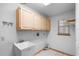Functional laundry room with ample storage, a utility sink, and natural light at 980 Marjorie Rawlings Dr, Deland, FL 32720