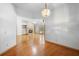 Open-concept living room with hardwood floors, fireplace, and built-in shelves at 980 Marjorie Rawlings Dr, Deland, FL 32720