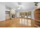 Sunlit living room features hardwood floors, fireplace, built-ins, and pool view at 980 Marjorie Rawlings Dr, Deland, FL 32720