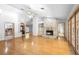 Spacious living room with hardwood floors, fireplace, and entry to the kitchen at 980 Marjorie Rawlings Dr, Deland, FL 32720