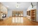 Living room with hardwood floors, fireplace, built-ins, and access to pool at 980 Marjorie Rawlings Dr, Deland, FL 32720