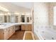 Main bathroom featuring double sinks, a shower, and a soaking tub at 980 Marjorie Rawlings Dr, Deland, FL 32720