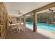 Outdoor patio with brick columns overlooking a luxurious pool area at 980 Marjorie Rawlings Dr, Deland, FL 32720