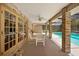 Covered patio with ceiling fan and an outdoor dining set by the pool at 980 Marjorie Rawlings Dr, Deland, FL 32720