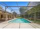 Large screened-in pool area featuring tiled pool and outdoor entertaining space at 980 Marjorie Rawlings Dr, Deland, FL 32720