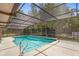 Beautiful pool area with screened enclosure and mature landscaping at 980 Marjorie Rawlings Dr, Deland, FL 32720
