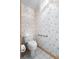 Powder room with wallpaper and tiled floor at 980 Marjorie Rawlings Dr, Deland, FL 32720