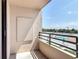 Balcony view of community pool, tropical foliage, and sunny sky at 1 Oceans West Blvd # 2A1, Daytona Beach, FL 32118