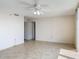 Bedroom features neutral tile flooring, ceiling fan, and lots of natural light at 1 Oceans West Blvd # 2A1, Daytona Beach, FL 32118