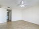Bedroom with neutral tile flooring, ceiling fan, and ensuite bathroom access at 1 Oceans West Blvd # 2A1, Daytona Beach, FL 32118