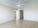 Bedroom includes neutral tile flooring, a ceiling fan, and ensuite bathroom access at 1 Oceans West Blvd # 2A1, Daytona Beach, FL 32118