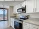 Bright kitchen featuring granite countertops and stainless steel appliances at 1 Oceans West Blvd # 2A1, Daytona Beach, FL 32118