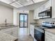 Kitchen features include granite countertops, stainless appliances, and a view to the lanai at 1 Oceans West Blvd # 2A1, Daytona Beach, FL 32118