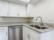 Kitchen features include stainless steel appliances, granite counters and white cabinets at 1 Oceans West Blvd # 2A1, Daytona Beach, FL 32118