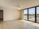 Light-filled living space with sliding glass doors to a balcony and ample natural light at 1 Oceans West Blvd # 2A1, Daytona Beach, FL 32118