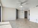Spacious living room with tiled flooring, ceiling fan, and balcony access at 1 Oceans West Blvd # 2A1, Daytona Beach, FL 32118