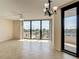 Bright, open living area with a ceiling fan, balcony access, and lots of natural light at 1 Oceans West Blvd # 2A1, Daytona Beach, FL 32118