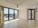 Sunlit living room featuring tiled floors and large sliding glass doors to the balcony at 1 Oceans West Blvd # 2A1, Daytona Beach, FL 32118