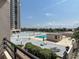 Enjoy a community pool with lounge seating surrounded by manicured greenery and ample space at 1 Oceans West Blvd # 2A1, Daytona Beach, FL 32118