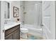 Well-lit bathroom features a vanity with a modern sink, toilet, and a shower-tub combination at 1000 Megano Blvd, Deland, FL 32724