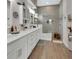 Bright bathroom featuring a double vanity, modern fixtures, a glass-enclosed shower, and decorative accents at 1000 Megano Blvd, Deland, FL 32724