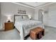 Bedroom with carpet flooring, a large bed, side tables, and tray ceiling at 1000 Megano Blvd, Deland, FL 32724
