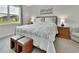 Bedroom with a bed, bedside tables, lamps, and a window with outdoor views at 1000 Megano Blvd, Deland, FL 32724