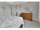 Bedroom featuring dresser, mirror, bedside table, and two white doors at 1000 Megano Blvd, Deland, FL 32724