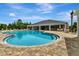Community pool with ample seating, perfect for relaxation and recreation, within a paved patio at 1000 Megano Blvd, Deland, FL 32724