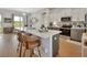 Modern kitchen featuring a spacious island with bar seating, white cabinetry, and stainless steel appliances at 1000 Megano Blvd, Deland, FL 32724