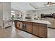 Open kitchen island with granite countertops, seating, and access to the living and dining areas at 1000 Megano Blvd, Deland, FL 32724