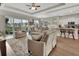 Comfortable living room with sliding glass doors to the outdoors, flowing into the kitchen with a breakfast bar at 1000 Megano Blvd, Deland, FL 32724