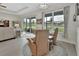Living room with seating, a large window with water views, and sliding door access at 1000 Megano Blvd, Deland, FL 32724