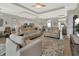 Open-concept living area boasts abundant natural light, wood floors, and a seamless flow to other living areas at 1000 Megano Blvd, Deland, FL 32724