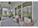 The screened porch features patio furniture and a ceiling fan, perfect for enjoying Florida weather at 1000 Megano Blvd, Deland, FL 32724