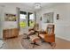 Sitting room featuring two leather chairs and a large window with backyard views at 1000 Megano Blvd, Deland, FL 32724