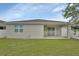 Well-maintained backyard with lush lawn, covered patio, and privacy fence at 1002 River Falls Cir, Deland, FL 32720
