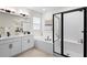 Updated bathroom with double vanity, soaking tub, and black framed glass shower at 1002 River Falls Cir, Deland, FL 32720
