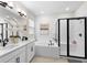 Modern bathroom featuring double vanity, soaking tub, and sleek glass-enclosed shower at 1002 River Falls Cir, Deland, FL 32720
