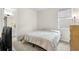 Simple, clean bedroom with a queen bed, neutral colors, and a window for natural light at 1002 River Falls Cir, Deland, FL 32720