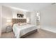 Bright bedroom boasts soft carpet, stylish headboard, and convenient ensuite bathroom access at 1002 River Falls Cir, Deland, FL 32720