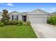 Charming single-story home with a well-manicured lawn and inviting entrance and two car garage at 1002 River Falls Cir, Deland, FL 32720