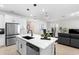 Open concept kitchen featuring an island with seating, stainless steel appliances, and access to dining/living area at 1002 River Falls Cir, Deland, FL 32720