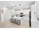 Bright kitchen featuring an island with seating, white cabinets, and modern appliances at 1002 River Falls Cir, Deland, FL 32720