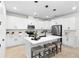 Modern kitchen with a center island, white cabinetry, stainless steel appliances, and pendant lighting at 1002 River Falls Cir, Deland, FL 32720