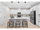 Modern kitchen with white cabinets, stainless appliances, and island with seating at 1002 River Falls Cir, Deland, FL 32720