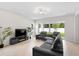 Bright living room with modern lighting, a sleek fireplace, and sliding doors to the backyard at 1002 River Falls Cir, Deland, FL 32720