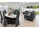Stylish living and dining area featuring modern furniture, wood floors, and ample natural light at 1002 River Falls Cir, Deland, FL 32720