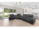 Bright, airy living room featuring a large sectional sofa and sliding doors to a lovely backyard at 1002 River Falls Cir, Deland, FL 32720