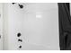 Clean, modern shower featuring white tiling and a black showerhead at 1002 River Falls Cir, Deland, FL 32720